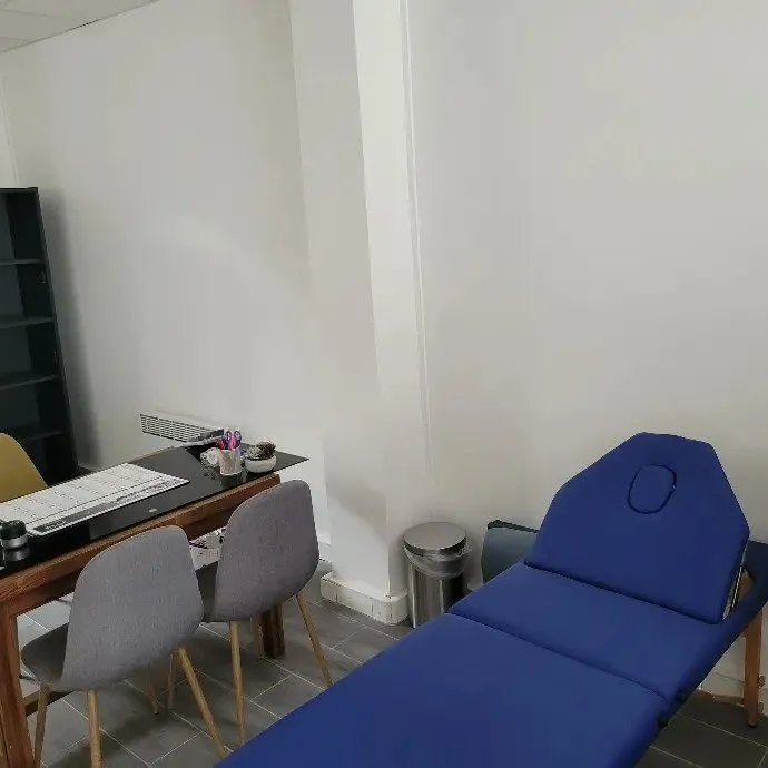 Poste de travail avec bureau, chaises et table de soins.
